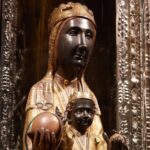 12th century statue of "Black Madonna of Montserrat" in cathedral of Montserrat Monastery in Barcelona Province, Catalonia, Spain. It is a statue of Mary and Jesus with black skin. The statute is behind glass with an orb held in Mary's hand protruding out of a hole so pilgrims can touch it.