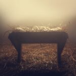 A photograph of a manger with fog around it.